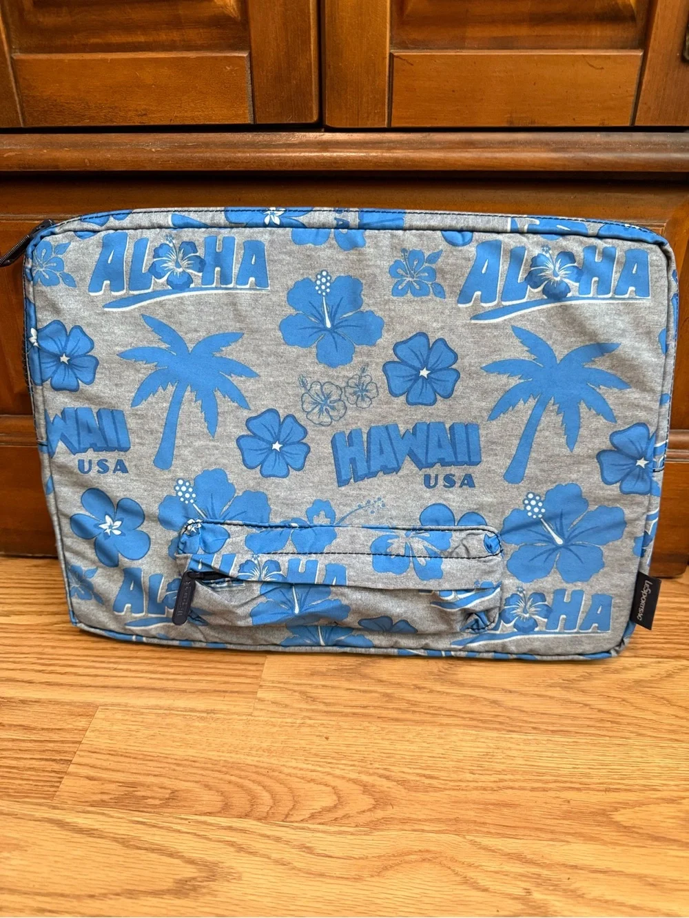 LeSportsac brand travel pouch or laptop case featuring a blue and grey hibiscus